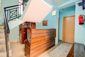 a staircase in a house with blue walls at Hotel O Casa Astra in Salua +26 photos
