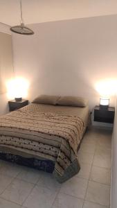 a bedroom with a bed with two lamps on it at Casa bella vista in Pocito +32 photos