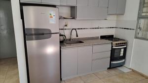 a kitchen with a refrigerator and a sink at Casa bella vista in Pocito
