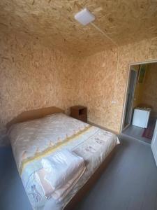 a bed in a small room with a window at Aragast White Beach in Sevan