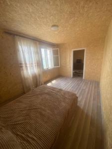 a large bed in a room with a window at Aragast White Beach in Sevan