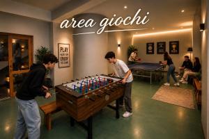 two men playing a game of foosball at RESIDENCE ALTAIR Via Roma 13 in Ovindoli