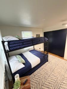 two bunk beds in a room with a rug at The Float House at Buckeye Lake - Hot Tub - Patio - Privacy in Thornville