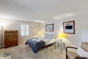 a bedroom with a bed and a dresser at Meant To Beach in Edisto Beach +18 photos