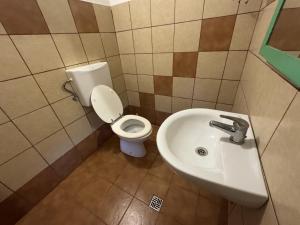 a bathroom with a toilet and a sink at Nurral - TENT in Fertilia