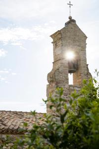 
a tall tower with a clock on it's side at Nun Assisi Relais & Spa Museum in Assisi
