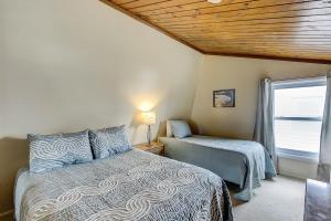 a bedroom with a bed and a window at Driftwood Villa - 237 in Edisto Beach
