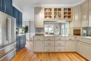a large kitchen with white cabinets and wood floors at Sto-Away in Edisto Beach