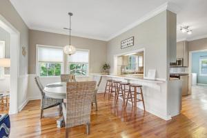 a dining room and kitchen with a table and chairs at Sto-Away in Edisto Beach +42 photos