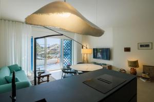 a kitchen and living room with a large light fixture at La Prua in Taormina