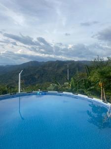 a swimming pool with a view of a mountain at La bendición de sunnyvale cabaña pequeña 4 personas in La Vega