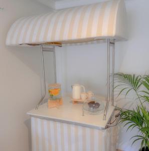 a bed with a striped canopy in a room at HOTEL SLOW STAY - Esposende in Esposende +26 photos