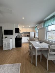 a kitchen and dining room with a table and chairs at 2 Minute Walk to Beach, Cape Cod Escape in Dennis Port