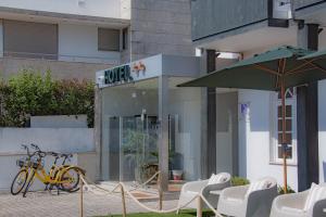 a cafe with a bike parked outside of a building at HOTEL SLOW STAY - Esposende in Esposende