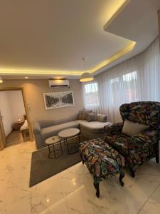 a living room with a couch and a chair at Apartman Simikic in Lopare +26 photos