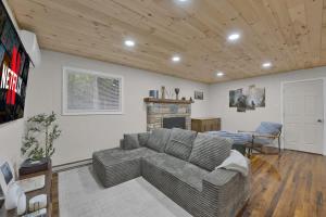 a living room with a couch and a fireplace at Private Cozy Cabin with Fire Pit in Locust Lakes Village