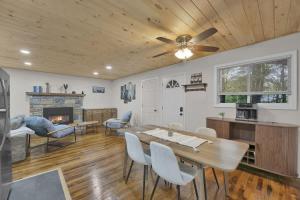 a living room with a table and a fireplace at Private Cozy Cabin with Fire Pit in Locust Lakes Village
