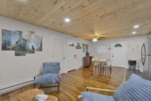 a living room with wooden ceilings and a table and chairs at Private Cozy Cabin with Fire Pit in Locust Lakes Village +7 photos