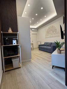 a living room with a couch and a table at Cagrovi Apartments in Casoria