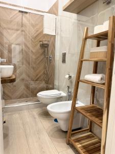 a bathroom with a shower and a toilet and a sink at Cagrovi Apartments in Casoria +21 photos
