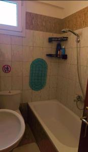 a bathroom with a tub and a toilet and a sink at Francesco's Apartment-Chalkidiki in Flogita +16 photos
