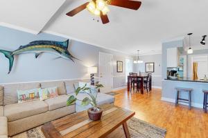 a living room with a couch and a table at Driftwood Villa - 262 in Edisto Beach