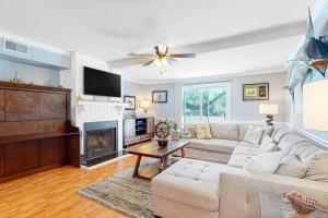 a living room with a couch and a fireplace at Driftwood Villa - 262 in Edisto Beach