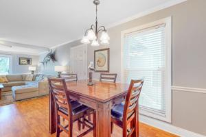 a dining room and living room with a table and chairs at Driftwood Villa - 262 in Edisto Beach