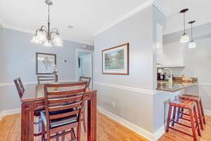 a kitchen and dining room with a table and chairs at Driftwood Villa - 262 in Edisto Beach