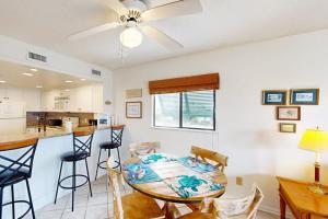 a kitchen and dining room with a table and chairs at Bay Creek Villa - 202 in Edisto Beach