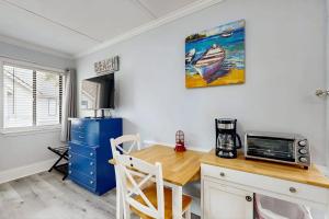 a kitchen with a wooden table and a microwave at Sea La Vie in Edisto Island