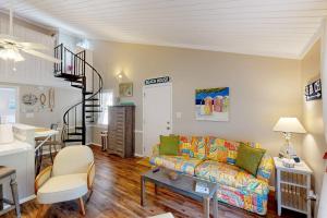 a living room with a couch and a stair case at Driftwood Villa - 267 in Edisto Island