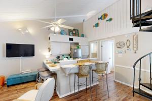 a kitchen and living room with a table and chairs at Driftwood Villa - 267 in Edisto Island