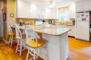 a kitchen with a large island with bar stools at Morillo's Miracle in Edisto Beach