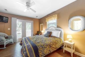 a bedroom with a bed and a ceiling fan at Morillo's Miracle in Edisto Beach