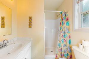 a bathroom with a sink and a shower curtain at Morillo's Miracle in Edisto Beach