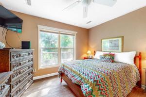 a bedroom with a bed with a dresser and a window at Morillo's Miracle in Edisto Beach +13 photos
