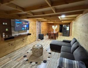 a living room with a couch and a tv at Hospedaje marylin in La Serena