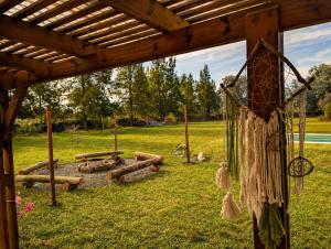 a pergola with a fire pit in a field at Quinta La llama violeta in Campana +8 photos