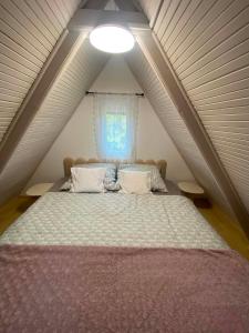 a bedroom with a large bed in a attic at Harmónia és Béke Csopak in Csopak