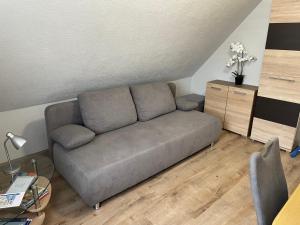 a living room with a gray couch in a room at Nina in Bad Wildungen