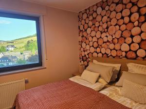 a bedroom with a large pile of logs on the wall at WOLL Forest in Schmallenberg