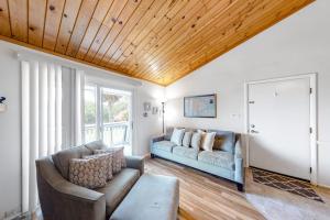 a living room with a couch and a window at Driftwood Villa - 259 in Edisto Beach