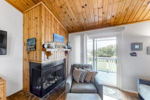 a living room with a couch and a fireplace at Driftwood Villa - 259 in Edisto Beach