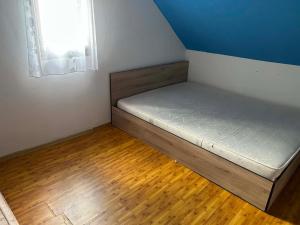 a small bed in a room with a window at Lucky lak in Miercurea-Ciuc