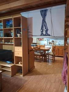 a living room with a table and a dining room at il Battito in Saint Vincent