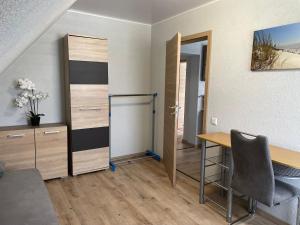 a room with a desk and a table and a door at Nina in Bad Wildungen