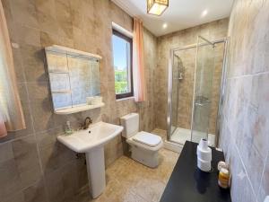 a bathroom with a toilet and a sink and a shower at D&D Rooms in Medulin