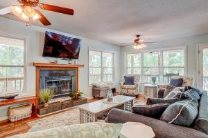 a living room with a fireplace and a tv at In Spite of Ourselves in Edisto Beach