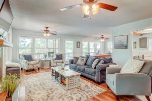 a living room with couches and a ceiling fan at In Spite of Ourselves in Edisto Beach